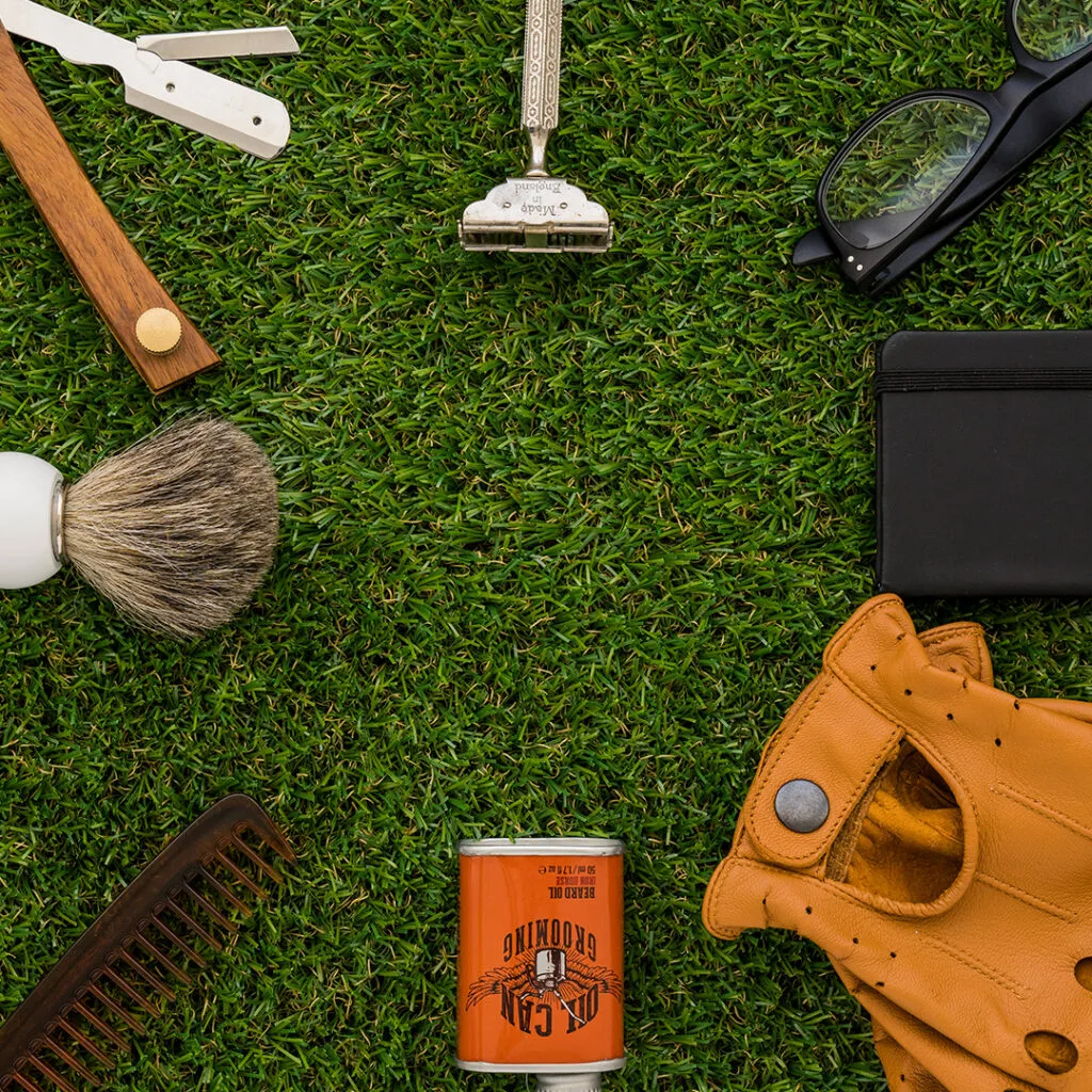 Various grooming and utility tools laid out on artificial grass, not directly related to affordable landscaping near me services.