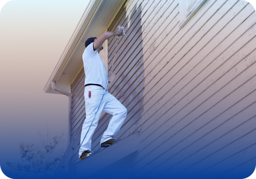 Home service professional painting the exterior wall of a house