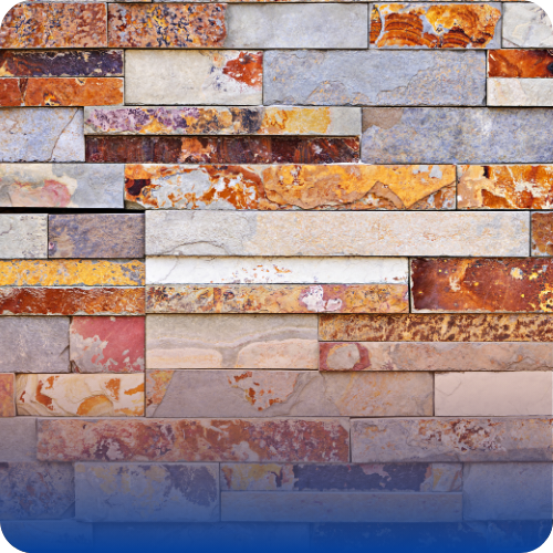 Decorative veneer masonry wall made of multicolored stone slabs arranged in a stacked pattern.