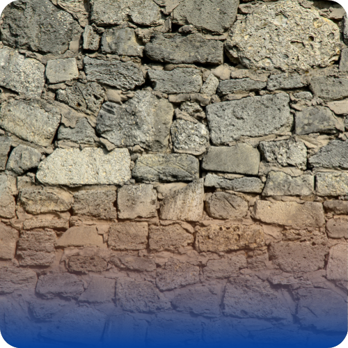 A stone masonry wall built with irregularly shaped stones fitted together.