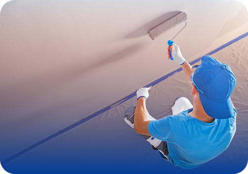 Painter on a ladder working on a wall