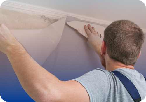 Service professional applying wallpaper to a wall