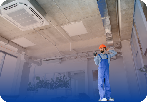 HVAC technician wearing a hardhat inspecting the job site