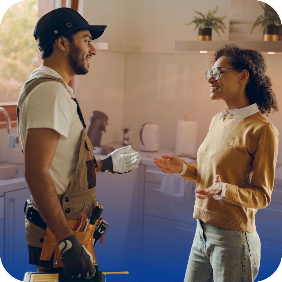 A man and woman discussing something in a cozy kitchen setting.