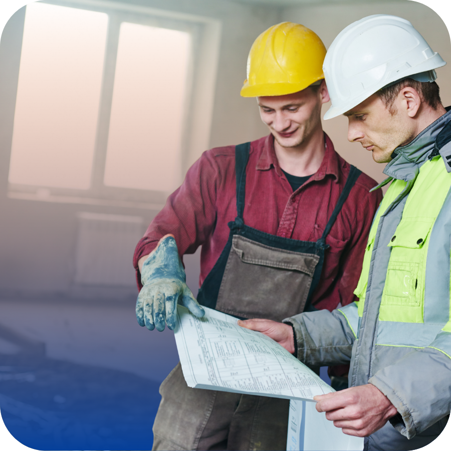 Two men in safety vests and hard hats reviewing a blueprint, focused on their construction plans.