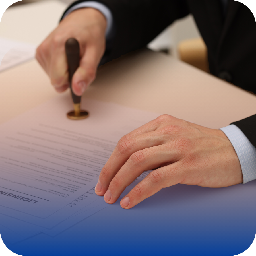 A suited individual uses a pen to stamp a piece of paper, signifying an official action or endorsement.