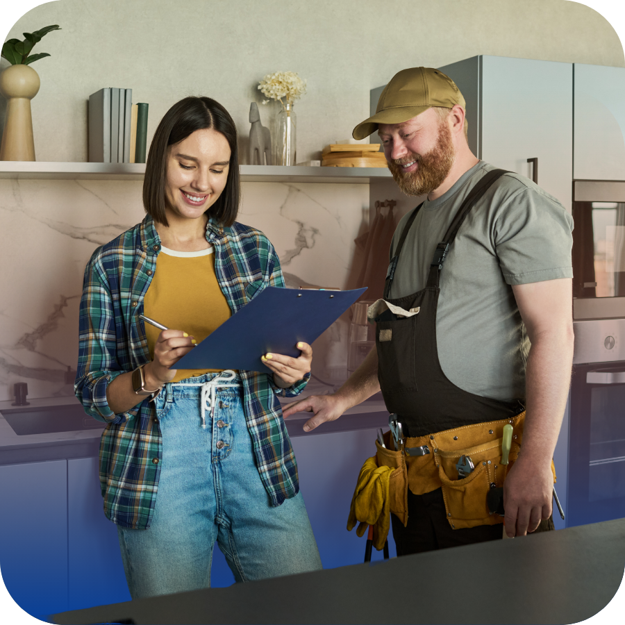 A man and woman in a kitchen, standing together with a clipboard, likely reviewing a list or project details.