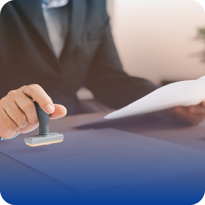 A business person's hand holding a stamp, symbolizing credential verification for contractors in a directory service.