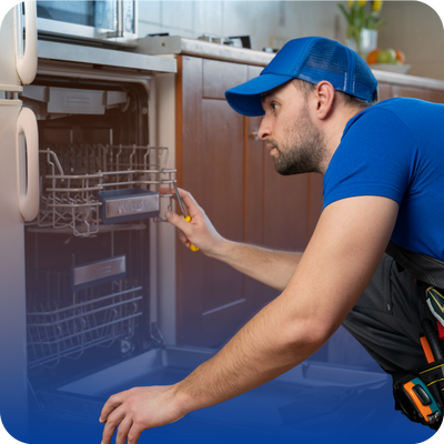 A man in a blue shirt and hat works on a dishwasher, illustrating practical home repair tips for homeowners.