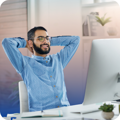 A man sitting at a desk, hands behind his head, reflecting on contractor options for homeowners.