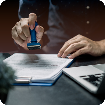 A person prepares to stamp a paper marked "Final Approval," representing the conclusion of a contractor's work for homeowners.