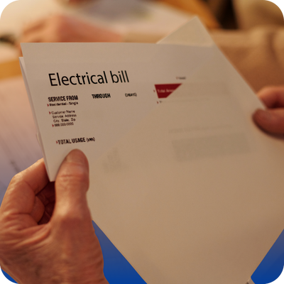 A person examines an electrical bill, emphasizing the need for homeowners to stay informed about their utility expenses.