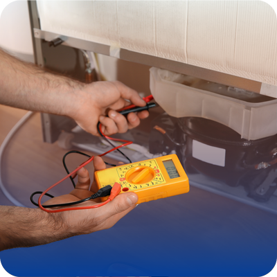 A person uses a digital multimeter to measure electrical values in a refrigerator’s internal components, possibly assessing the appliance repair cost before calling a local pro appliance repair service.