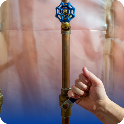 A hand holding a pipe featuring a blue and white spider, emphasizing the importance of checking for leaks.